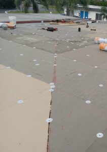 Flat roof replacement with taped insulation in order to create Slope